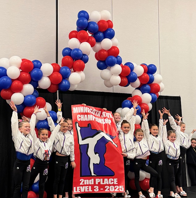 A youth cheerleading team celebrates their second-place win with a star-shaped balloon arrangement.